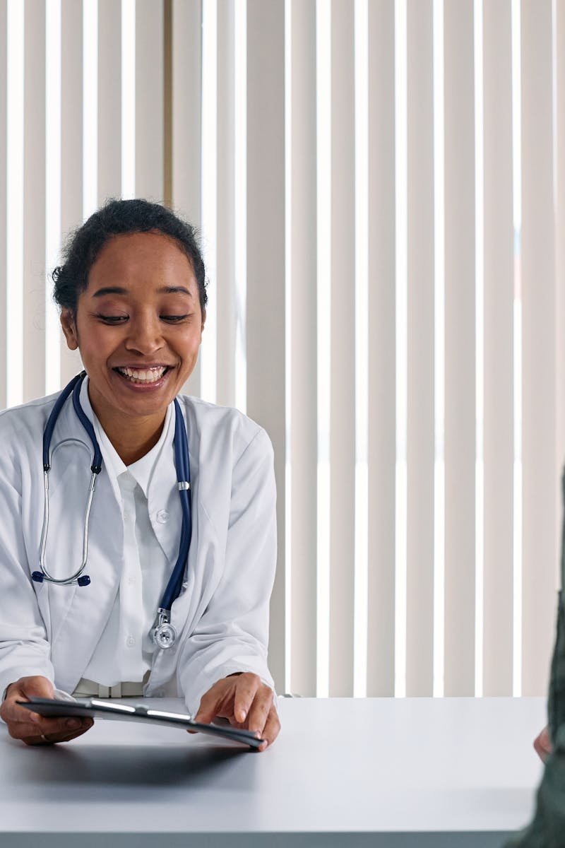 A doctor and patient engaging in a positive consultation in a bright clinic setting.